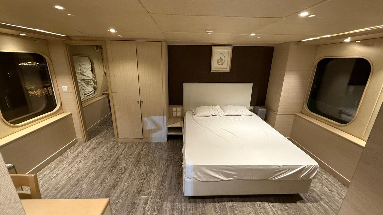 Private cabin with a double bed, wardrobe and large windows