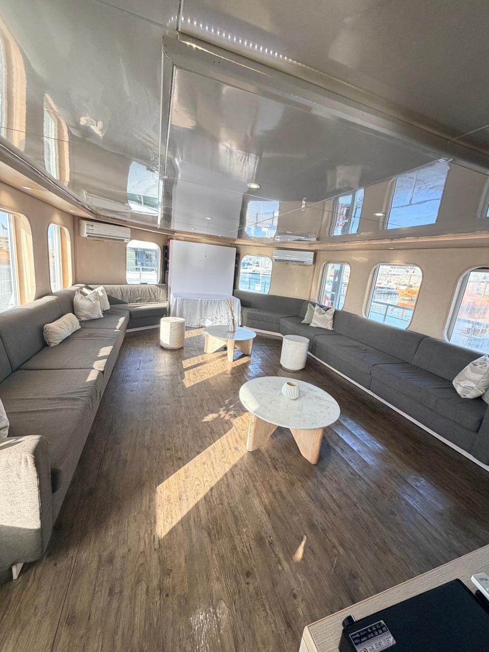Wide view of the air-conditioned lounge with wraparound sofa seating