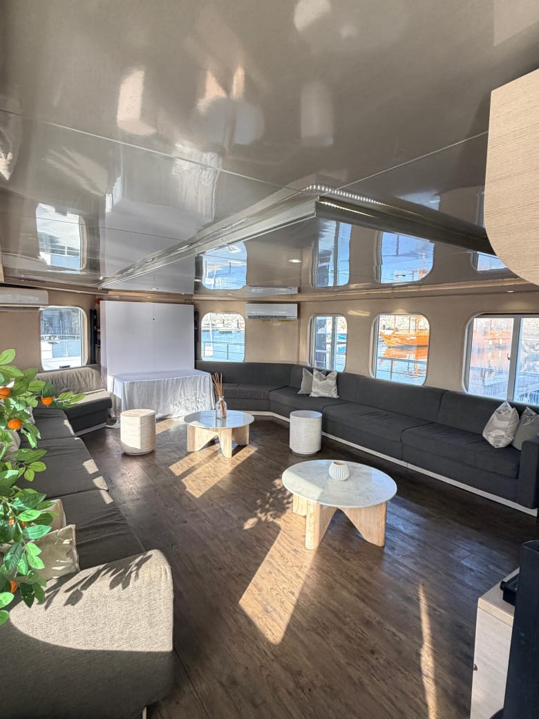 Lounge seating beside large windows overlooking the marina