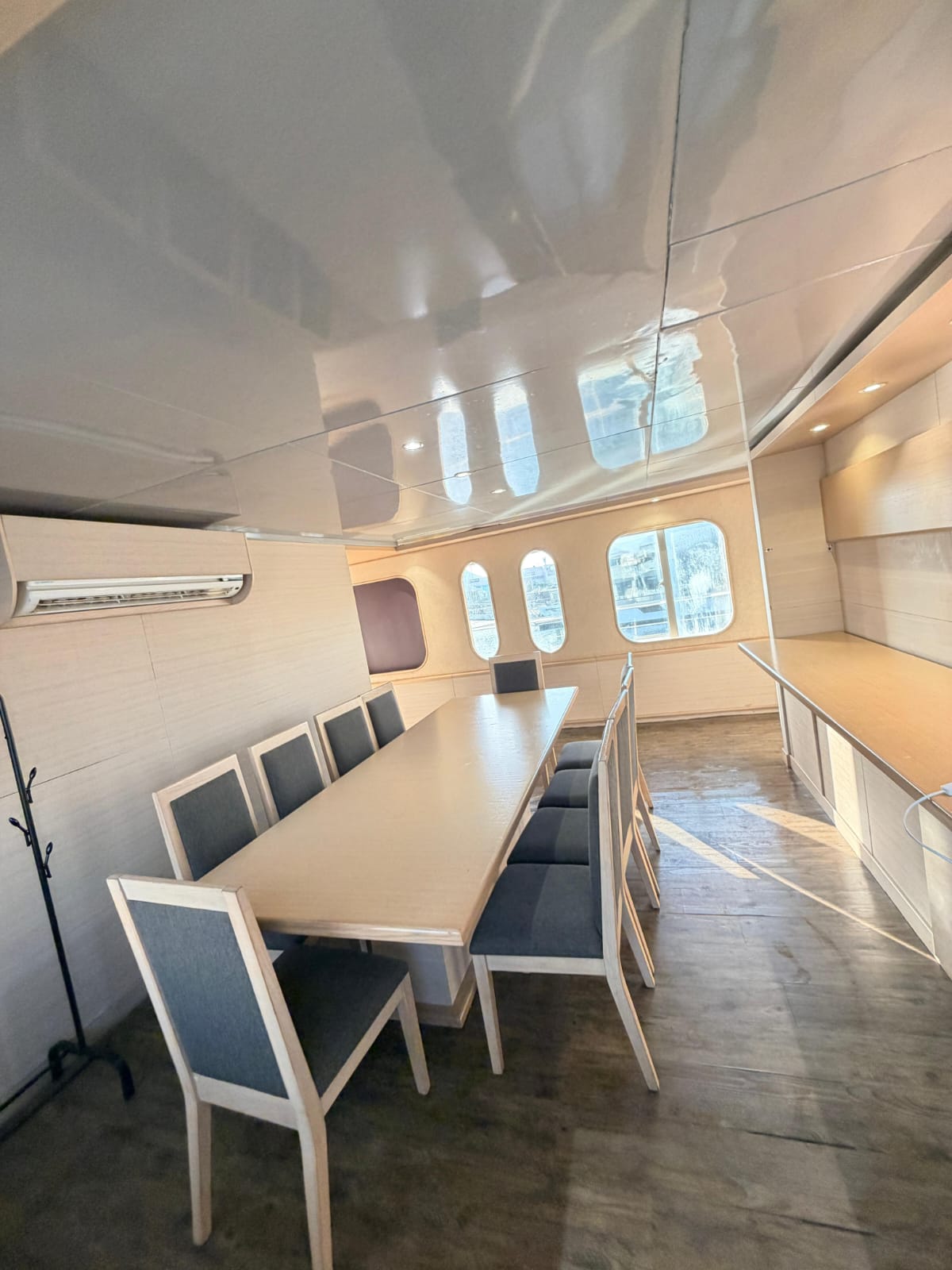 Dining room with air-conditioning, porthole windows and seating for a group