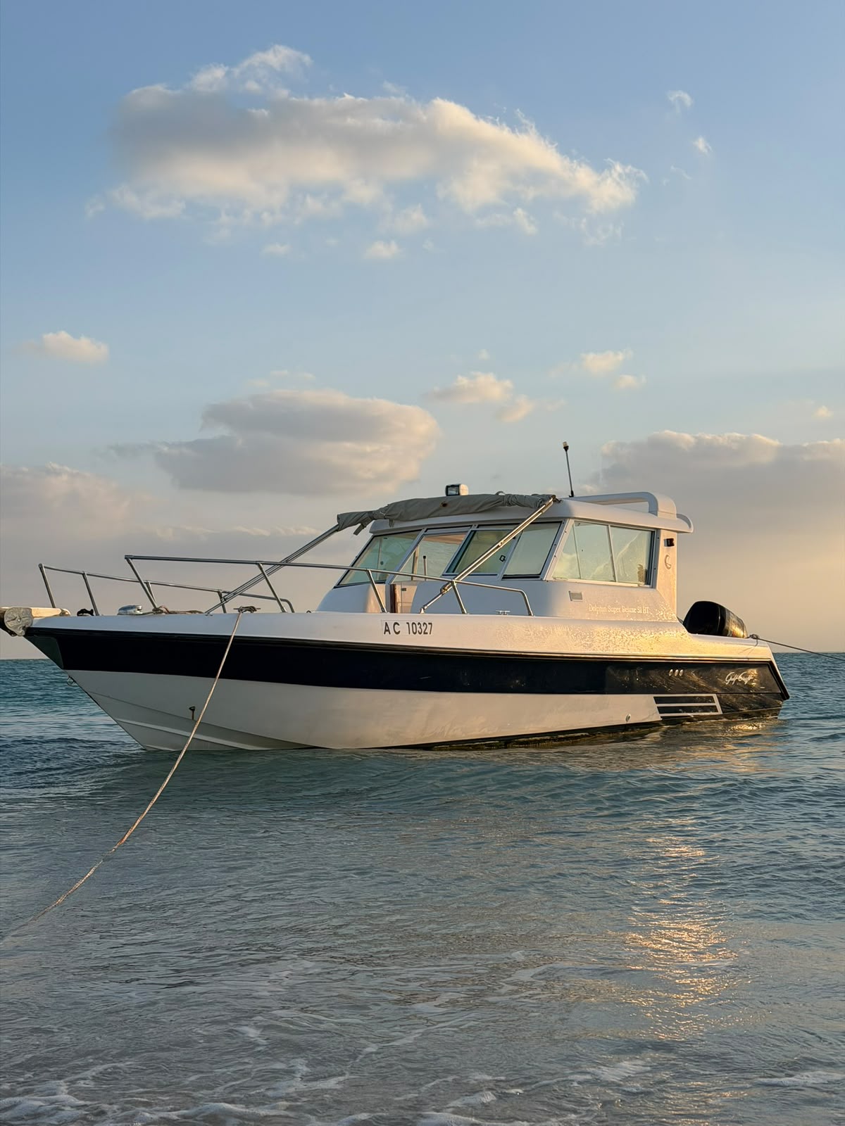 33 ft private boat anchored in shallow turquoise water off an Abu Dhabi beach