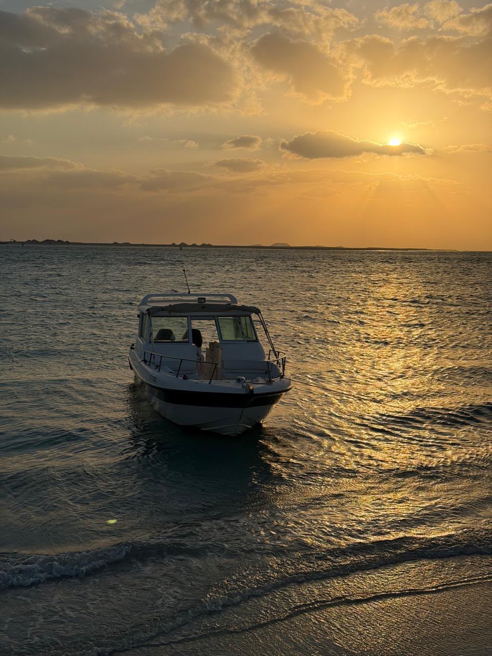 Big Boats charter boat cruising the Abu Dhabi coastline at sunset