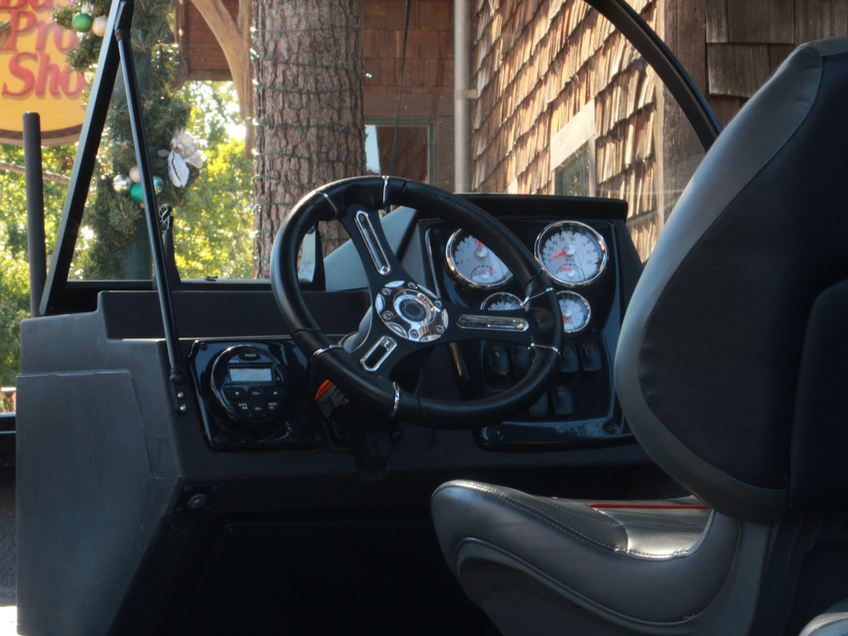 Boat helm dashboard with gauges and electronics