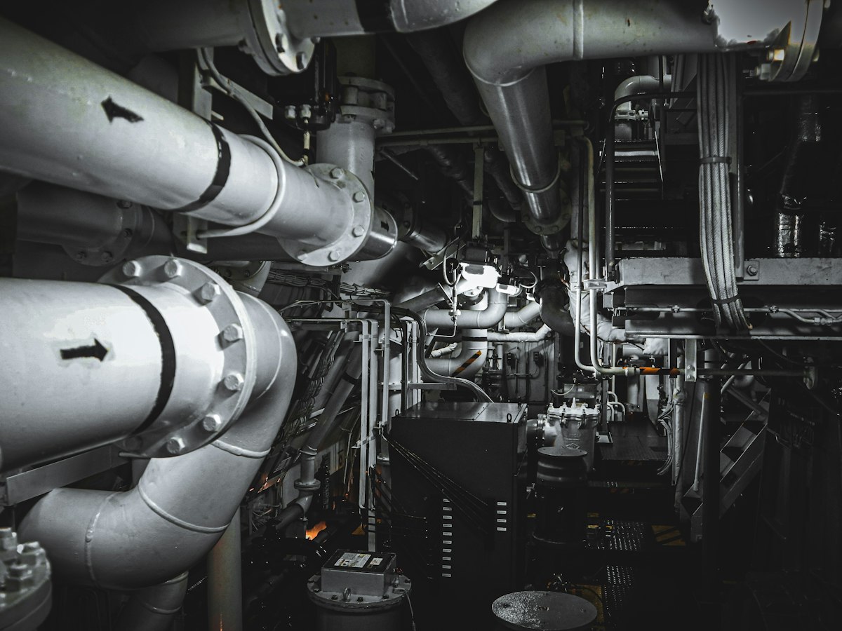 Marine engine room with pipes and machinery