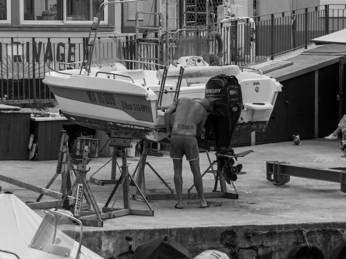 Technician carrying out mechanical repairs on a boat engine