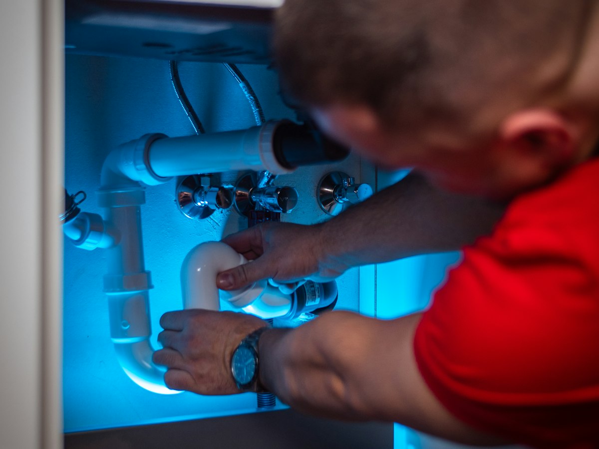 Technician repairing plumbing pipes